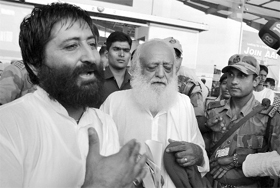 Asaram and his son Narayan Sai come out of Raja Bhoj Airport after they missed the flight, in Bhopal on Friday.