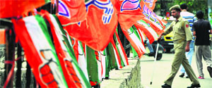 Congress and BJP flags dot Jewel Chowk ahead of BJP chief Rajnath Singh and AICC general secretary Ambika Sonis visit in Jammu on Friday.
