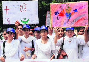 Students of Government College for Women, Gandhi Nagar, hold a rally on peace and communal harmony in Jammu on Friday. 