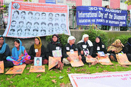 Members of the Association of Parents of Disappeared Persons hold pictures of their missing family members during a protest in Srinagar on Friday. 