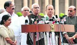 BJP leader LK Advani (C) flanked by other party leaders addresses mediapersons after meeting President Pranab Mukherjee in New Delhi on Friday. Tribune photo: Mukesh Aggarwal