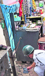 A member of the bomb disposal squad inspects the scene of the blast in Kolkata on Friday.  PTI 