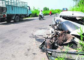 Mangled remains of a car which collided with a Canter near Rajasansi in Amritsar on Saturday