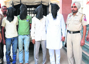 The three members of a gang of thieves along with the junk dealer, who used to buy the stolen item, in the custody of the police. 