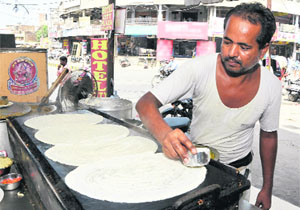 A cook prepares a dosa at the the Nand Lal Juice Corner in Bathinda on Saturday. 