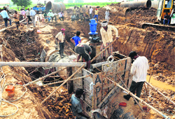 Workers carry out repair work at Gharuan village on Saturday. Tribune photos: Parvesh Chauhan