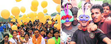A candidate canvasses with supporters holding balloons in DAV College, Dehradun, on Saturday. (Right) Supporters of a candidate in the students council elections wear masks in DAV College, Dehradun.