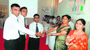 Students of Army Public School receive the winning trophy in the Inter-School Living Science Quiz-2013, held at The Indian Academy on Saturday. 