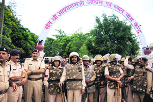 Policemen guard Asaram's ashram in Indore on Saturday.