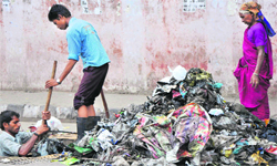 A file photo of JMC workers cleaning a drain in Jammu.