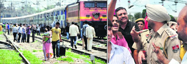Passengers were left stranded after the railway employees blocked the traffic under the Jagraon bridge; and (right) some of them argue with a police officer in Ludhiana.