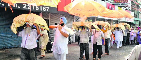 Devotees take out a procession on the birth anniversary of Baba Wadbhag Singh in Patiala on Saturday.
