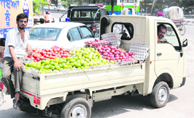 Vendors sell fruits on a vehicle on a hot summer day in Bathinda.