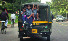 An overloaded auto-rickshaw ferries schoolchildren in Chandigarh.
