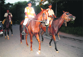 The mounted police personnel keep vigil along the boundary wall of Panjab University 