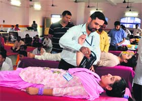 A student donates blood at a donation camp organised by Dev Sanskriti University, Shantikunj in Haridwar on Sunday