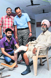 Experts from Jaipur fix an artificial limb on Barkat Singh in Jammu on Sunday.