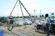 Employees busy with the construction of a flyover at the Jawahar NagarRambagh crossing in Srinagar on Sunday.