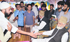 Syed Ali Shah Geelani shakes hands with party supporters after being re-elected as Tehreek-e-Hurriyat chairman in Srinagar on Sunday.