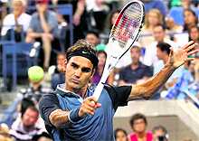 Roger Federer returns a backhand to Adrian Mannarino at the US Open in New York on Saturday