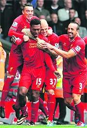 Daniel Sturridge (15) celebrates scoring against Manchester United with teammates during their English Premier League match in Liverpool on Sunday
