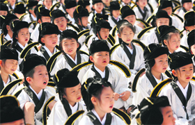 Pupils in traditional costumes attend a ceremony at the Confucius temple in Jiaansu, China, on Sunday.