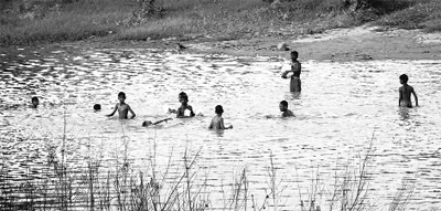 Children taking a dip in contaminated water at the rear of Burail Jail in Chandigarh