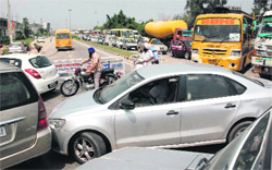 Traffic police personnel divert traffic to Chatt village on the Ambala-Chandigarh Highway following a protest by farmers on Monday. 