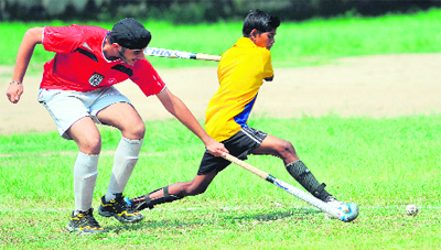  Players struggle for the ball during a hockey match at Government Model Senior Secondary School, Sector 37, in Chandigarh on Monday.