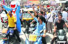 Supporters of a candidate for the students union poll at DAV (PG) College take out a two-wheeler march 