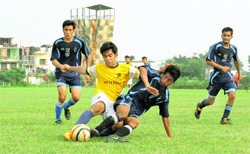 Players vie for the ball in the RIMC Soccer Cup being played in Dehradun on Monday.