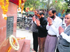 Urban Development Minister Preetam Singh Panwar (second from left) pays homage to martyrs on the 19th anniversary of the Mussoorie police firing on Monday.