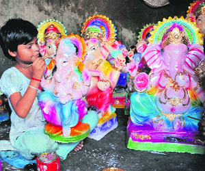 Mamta Kumari, a class II student colours an idol of Lord Ganpati for the upcoming festival of Ganesh Chaturthi in Jammu.