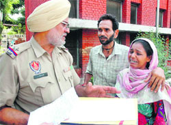 Malkiat Kaur, wife of HIV-positive patient Ram Kishan, who committed suicide by jumping down from the second floor of the Civil Hospital, in an inconsolable condition in Jalandhar on Monday.