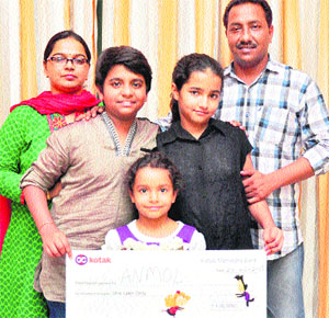 Anmol Jaswal with his family at Jammu on Monday. Anmol finished in top four in Indian Idol Junior.
