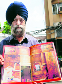Writer Onkar Singh Sandhu shows pictures of the structure.