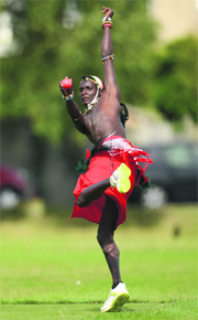 A cricketer from the Masai tribe bowls during a match against English team 'The Shed' in the Last Man Stands tournament in London.