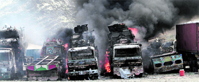 Smoke rises from NATO supply trucks following an attack by militants in the Torkham area near the Pakistan-Afghanistan border in Jalalabad province east of Kabul, Afghanistan, on Monday.