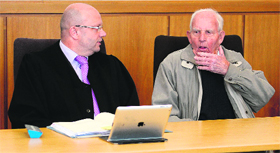 Dutch-born German former SS officer Siert Bruins (R) and his lawyer Klaus-Peter Kniffka (L) sit in the court room in Hagen, western Germany, on Monday.