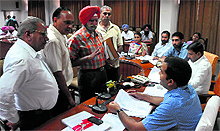 Deputy Commissioner Kamal Kishore Yadav hears out complainants during a grievance redressal meeting held at District Administrative Complex in Bathinda on Tuesday
