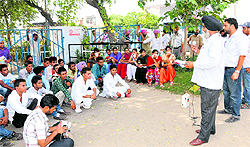 PRTC depot in-charge Gurjant Singh speaks to members of Punjab Students Union at Bathinda bus stand on Tuesday