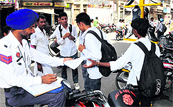 Police officials issue challans to students for breaking traffic rules near Arya Samaj Chowk in Bathinda