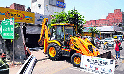 A JCB machine of the municipal corporation waited for two hours to demolish an alleged illegal structure at Teen Koni on Tuesday. It was subsequently sent back