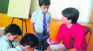 Atanu, a renowned illustrator and artist, helps students enhance their artistic skills during Ghummakkad Narain, a childrens festival, in Haridwar on Tuesday. 
