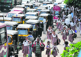 Schoolchildren hire private autorickshaws and vans to go home in Jammu. 