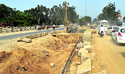 Diverted traffic moves at a snails pace after one side of the road leading to the southern bypass was closed to traffic due to the construction of a bridge on the Ferozepur road