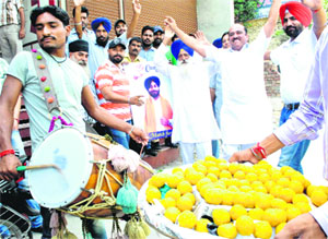 Akali supporters celebrate Sukhbir Badals re-election with sweets in Patiala. 