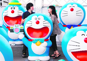 Visitors look at Japanese anime manga character Doraemons figures displayed to celebrate the characters birthday during an exhibition in Tokyo on Tuesday. 