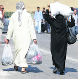 Syrian refugees carry their belongings after entering Turkish territory on Tuesday. 