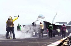 An F/A-18F Super Hornet assigned to the Black Knights of Strike Fighter Squadron (VFA) 154 prepares to launch from the flight deck of the aircraft carrier USS Nimitz in the Red Sea on Tuesday